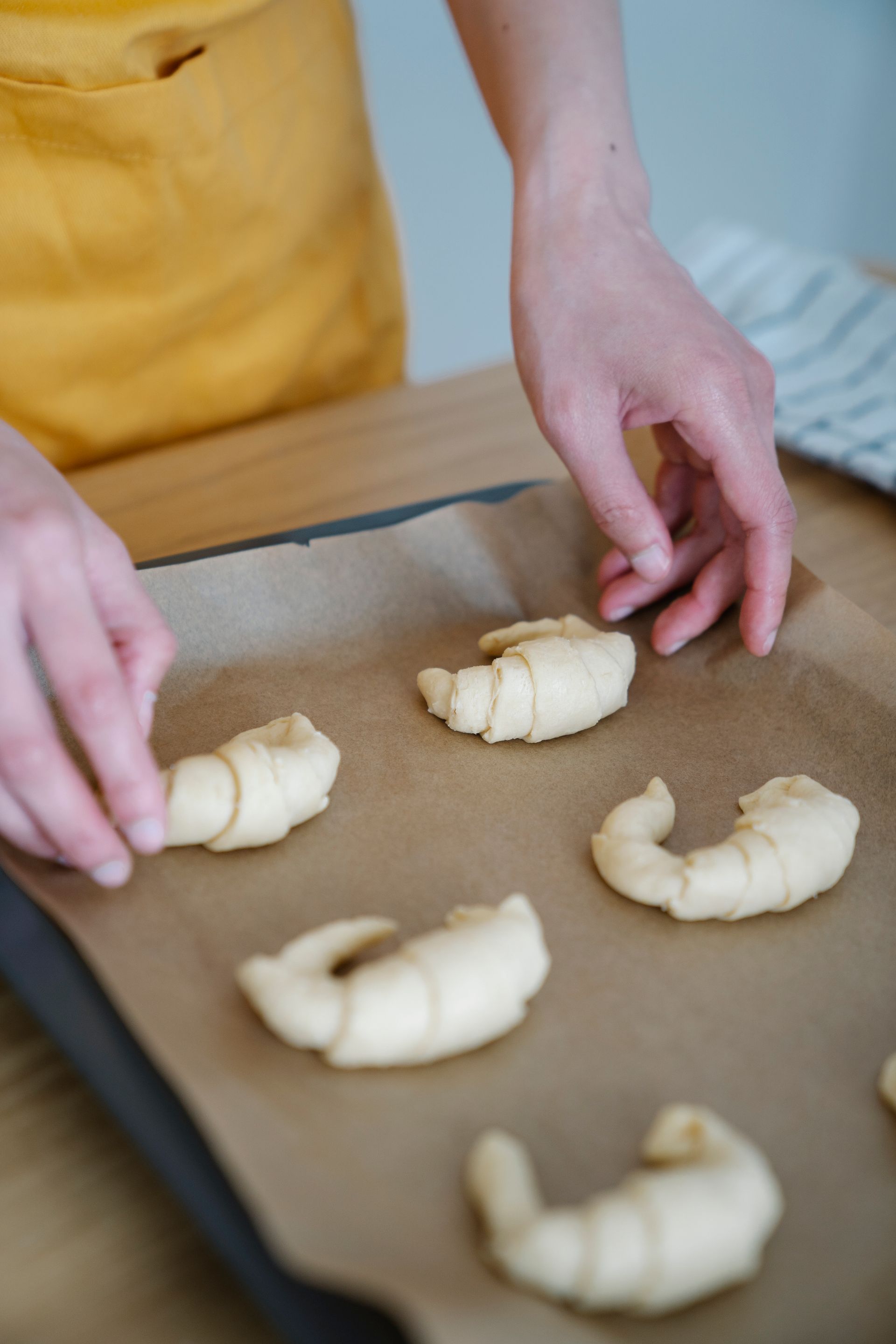 A pastry chef shaping croissants